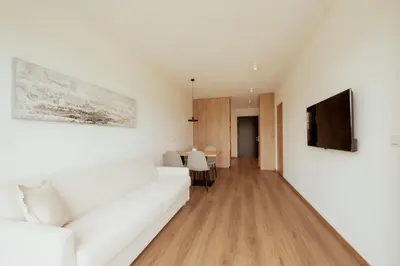 a living room with a white couch and a television at Gutshof Ebner in San Paolo