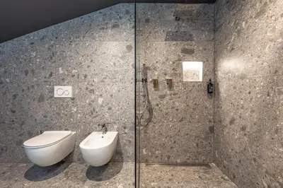 a bathroom with a shower with a toilet and a sink at Moarhof - Apartments and moar in Varna