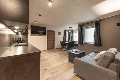 a living room with a couch and a kitchen at Moarhof - Apartments and moar in Varna