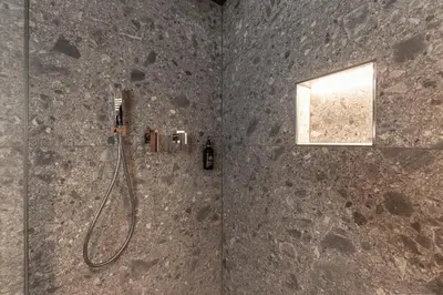 a bathroom with a shower with a glass door at Moarhof - Apartments and moar in Varna