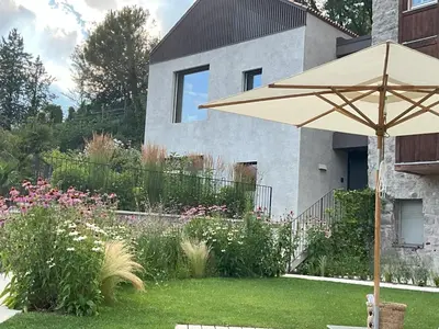 an umbrella in the yard of a house at Villa Tschaupp in Tirolo