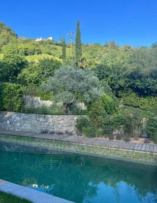 a pool of water next to a stone wall at Villa Tschaupp in Tirolo
