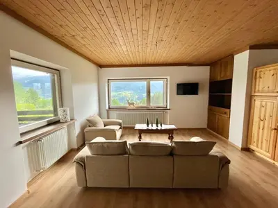 a living room with a couch and a table at Mountain Chalet Tre Marie in Cavalese