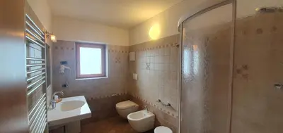 a bathroom with a sink and a toilet and a shower at Appartamento da Meto in San Martino di Castrozza