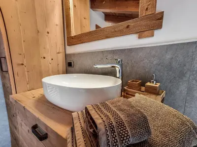 a bathroom with a white sink and a mirror at Casa Panoràma in the heart of the Dolomites, Moena in Moena