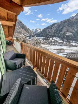 a balcony with chairs and a view of the mountains at Casa Panoràma in the heart of the Dolomites, Moena in Moena