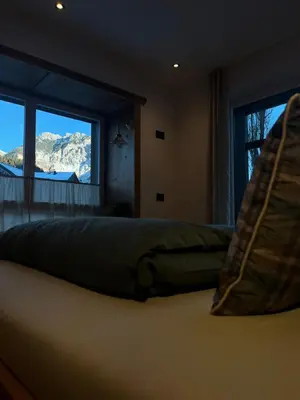 a bedroom with a bed with a view of a mountain at Ciasa Valiares in San Vigilio Di Marebbe