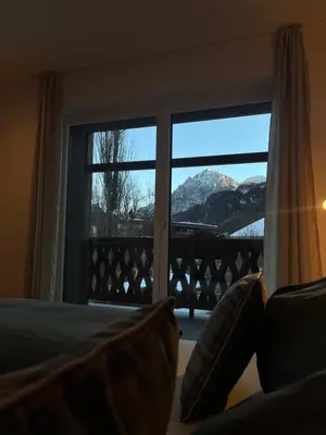 a bedroom with a window with a view of a mountain at Ciasa Valiares in San Vigilio Di Marebbe