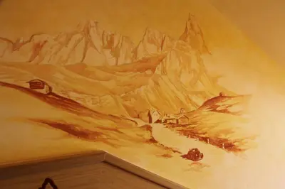 a painting of a mountain on a wall at Albergo Venezia in Passo Rolle
