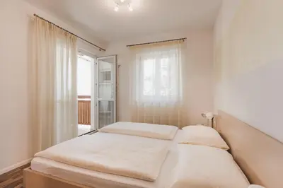 a bedroom with two beds and a window at Ansitz Rynnhof in Termeno