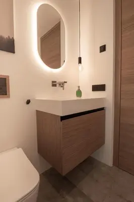 a bathroom with a sink and a mirror at Luxury Penthouse - Between Kronplatz, 3 Peaks Dolomites and Lake Prags in Monguelfo