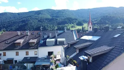 an overhead view of a town with a church and buildings at Luxury Penthouse - Between Kronplatz, 3 Peaks Dolomites and Lake Prags in Monguelfo