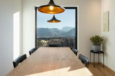 a large wooden table in a room with a large window at Ferienhaus Obergfillhof in Missiano