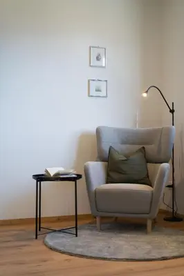 a living room with a chair and a table with a lamp at Ferienhaus Obergfillhof in Missiano