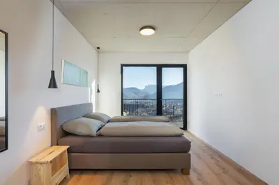 a bedroom with a bed and a large window at Ferienhaus Obergfillhof in Missiano