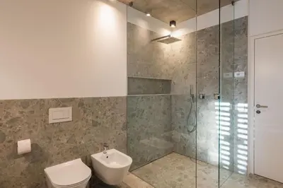 a bathroom with a shower and a toilet and a sink at Ferienhaus Obergfillhof in Missiano