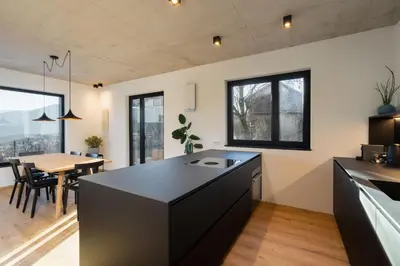 an open kitchen and dining room with a table at Ferienhaus Obergfillhof in Missiano