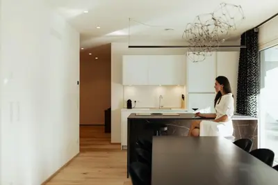a woman sitting at a kitchen counter in a kitchen at The Hills in Merano