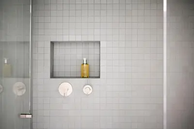 a bathroom with a shower with a yellow soap bottle at Mynt Merano Rooms in Merano