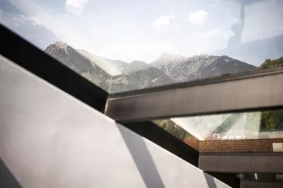 a view of a mountain range from a window at Mynt Merano Rooms in Merano