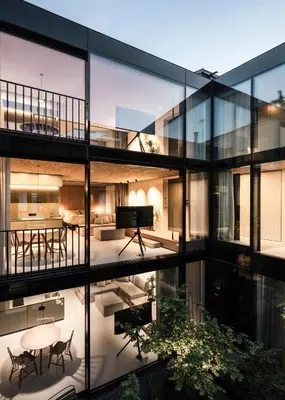 an apartment building with a view of a living room and a piano at Mynt Merano Rooms in Merano