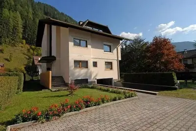 a house with a garden in front of it at CASA PINUCCIA APPARTAMENTO EST in Predazzo