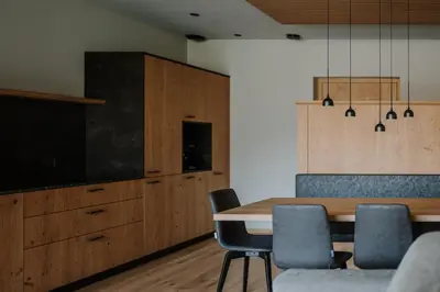 a dining room with a table and chairs and a tv at Stollhof in Lagundo
