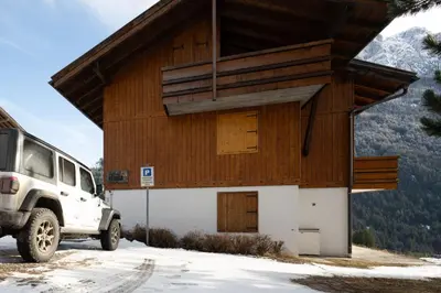 a vehicle parked in front of a building at Cesa Azola in Vigo di Fassa