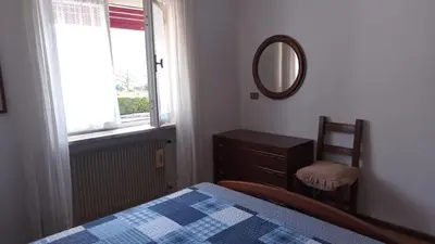 a bedroom with a bed and a mirror and a dresser at Casa vacanze a Romeno in Romeno