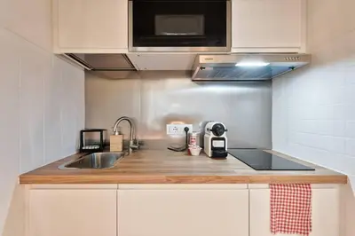a kitchen counter with a sink and a microwave at Lauben Studio Bolzano in Bolzano