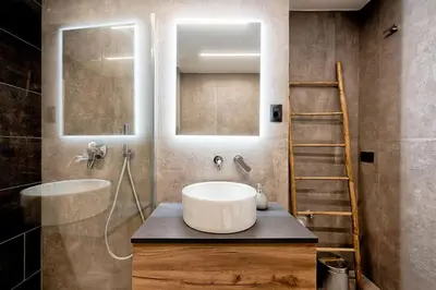 a bathroom with a white sink and a ladder at Lauben Studio Bolzano in Bolzano