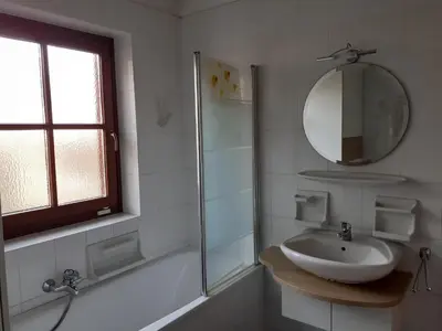 a white bathroom with a sink and a mirror at Zirbentraum in Lana