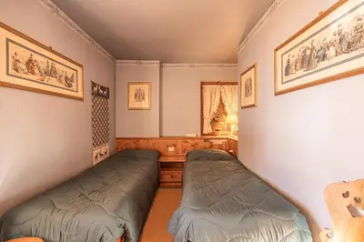 a bedroom with two beds in a room at Casa Allegra, con balcone panoramico in San Vito di Cadore