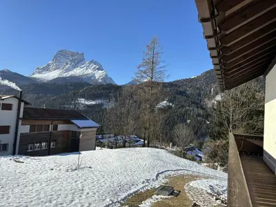 a snow covered hill with a mountain in the background at Casa Allegra, con balcone panoramico in San Vito di Cadore