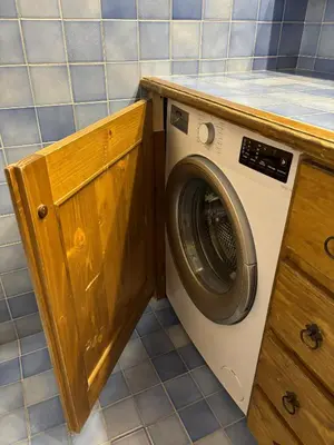 a washing machine in a bathroom with a counter at Casa Allegra, con balcone panoramico in San Vito di Cadore