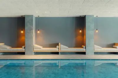 a row of benches in a swimming pool at Hotel Tofana Cortina in Cortina dʼAmpezzo