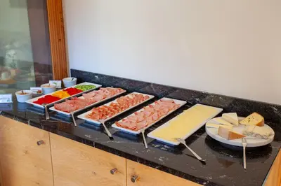 a buffet with many different types of meats and cheese at Pension Astoria in Naturno