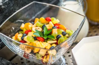 a glass bowl filled with fruit salad on a table at Pension Astoria in Naturno