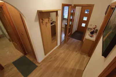 an overhead view of a hallway with two open doors at Appartamenti Ciasa Molin in Soraga