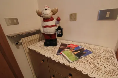 a santa claus toy sitting on top of a table at Appartamenti Ciasa Molin in Soraga