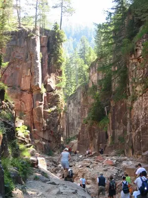 a group of people walking through a rocky canyon at Garni Sonnegg in Petersberg
