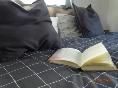 an open book sitting on top of a bed at Panoramaterrace, Wein & relax in Appiano Sulla Strada Del Vino