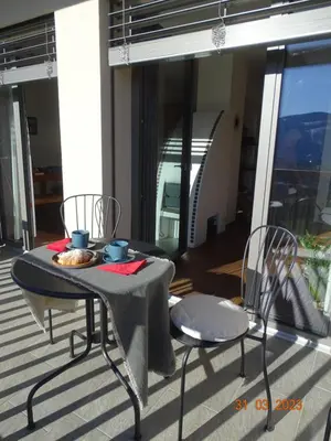 a table and chairs sitting on a balcony with a table and chairs at Panoramaterrace, Wein & relax in Appiano Sulla Strada Del Vino