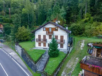 a small house on the side of a road at mansarda Lungolago in Alleghe