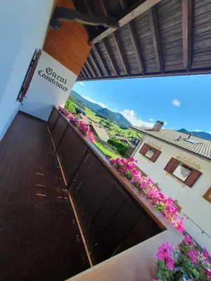 a view from the balcony of a hotel with flowers at B&B Garni Lantschner in Kastelruth