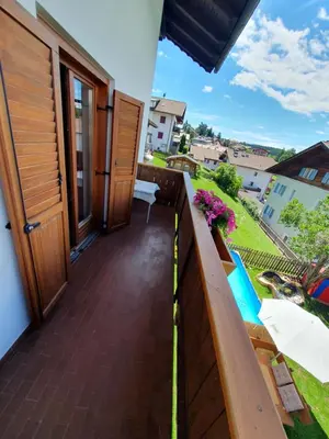 a balcony with a view of a building at B&B Garni Lantschner in Kastelruth