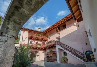 a building with stairs and balconies on it at Ferienhof Hanna in Termeno