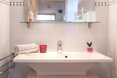 a white sink in a bathroom with a mirror at Ferienhof Hanna in Termeno