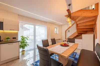 a kitchen and dining room with a table and chairs at Ferienhof Hanna in Termeno