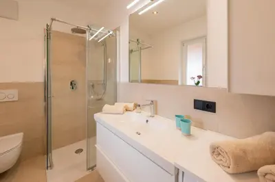 a bathroom with a sink and a shower at Ferienhof Hanna in Termeno